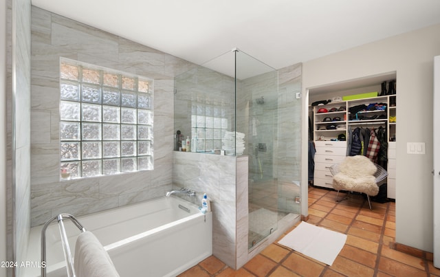 bathroom featuring shower with separate bathtub, tile patterned floors, and plenty of natural light