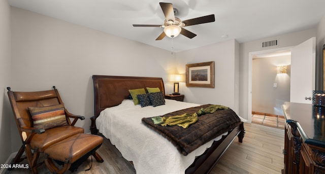 bedroom with wood-type flooring and ceiling fan