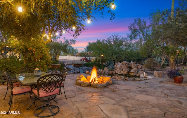 patio terrace at dusk with an outdoor fire pit