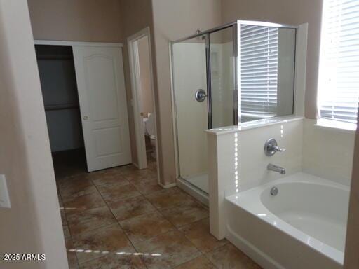 full bath featuring tile patterned floors, a garden tub, toilet, and a stall shower