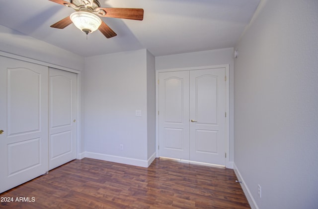 unfurnished bedroom featuring ceiling fan and dark wood-type flooring