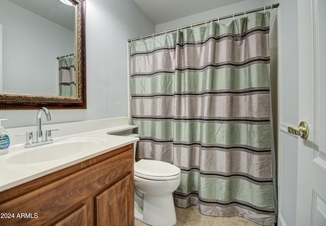 bathroom featuring toilet, vanity, a shower with curtain, and tile patterned floors