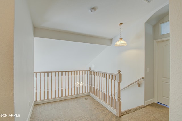 hall featuring lofted ceiling