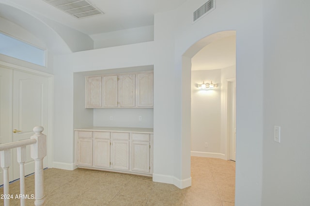 corridor featuring light tile patterned flooring