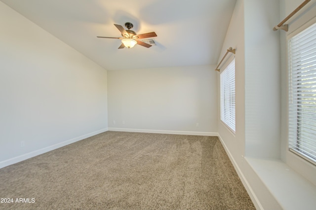 unfurnished room with ceiling fan, carpet, and vaulted ceiling