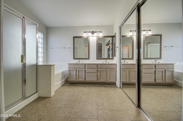 bathroom with tile patterned flooring, shower with separate bathtub, and vanity