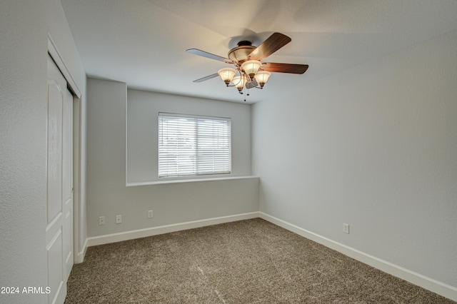 unfurnished bedroom with ceiling fan, a closet, and carpet flooring