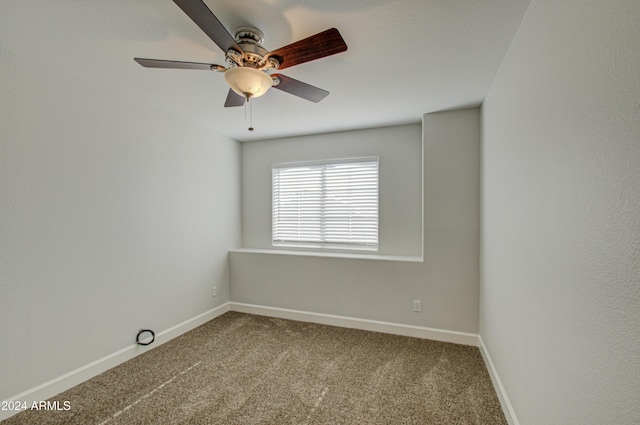 spare room featuring carpet floors and ceiling fan