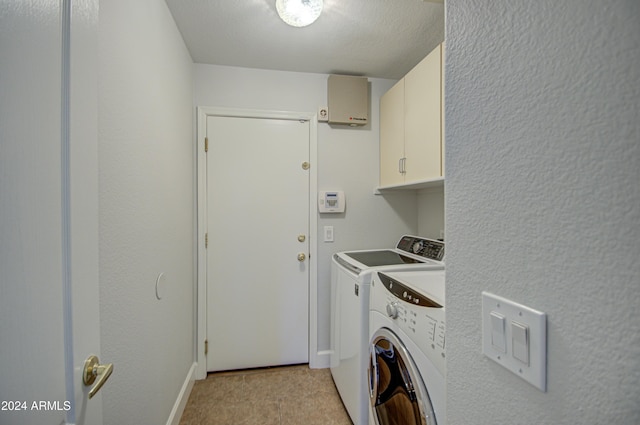 laundry room featuring cabinets and separate washer and dryer