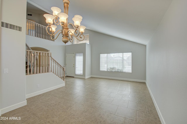 interior space featuring high vaulted ceiling and a notable chandelier