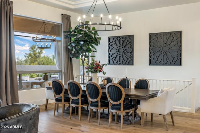 dining area with a notable chandelier and wood finished floors