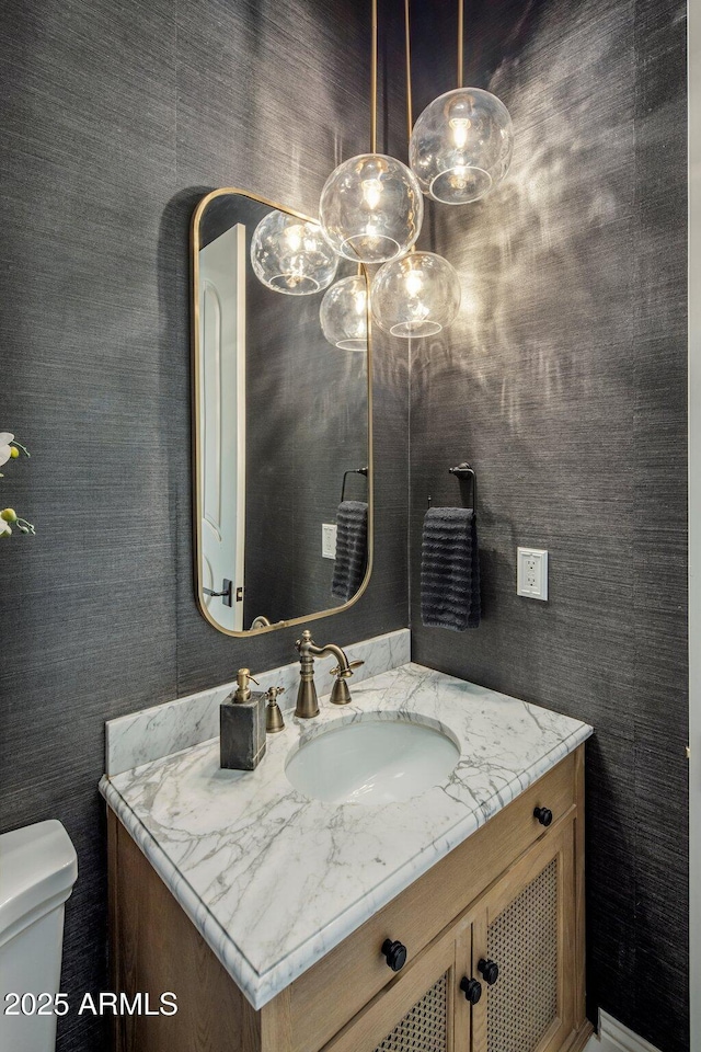 bathroom featuring toilet and vanity