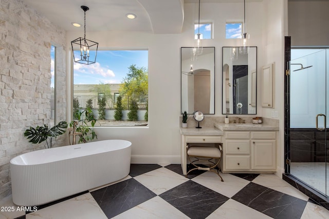 bathroom featuring vanity, marble finish floor, recessed lighting, a freestanding bath, and a stall shower