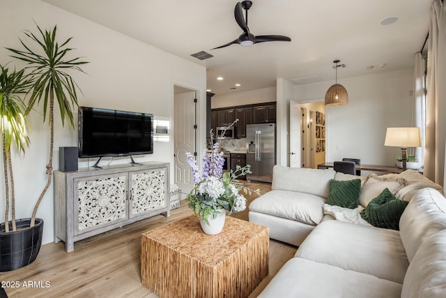 living area with ceiling fan, recessed lighting, light wood-style flooring, and visible vents