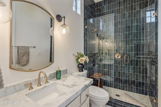 full bath with vanity, toilet, a wealth of natural light, and a stall shower