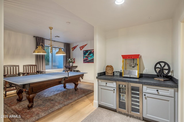 recreation room featuring wine cooler, pool table, a dry bar, and light wood-type flooring