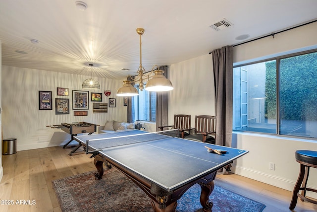 recreation room with wood-type flooring, baseboards, and visible vents
