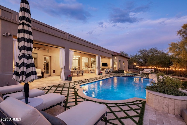 view of pool featuring a patio, outdoor lounge area, and a fenced in pool