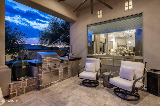 view of patio with an outdoor kitchen and a grill