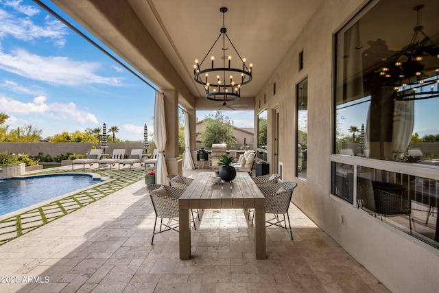 view of patio with fence, a fenced in pool, and outdoor dining area