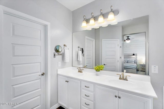 ensuite bathroom featuring a sink, double vanity, ceiling fan, and ensuite bathroom