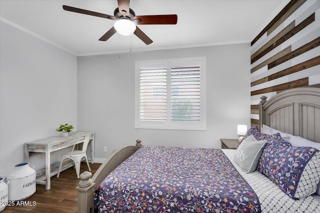 bedroom featuring wood finish floors, baseboards, ceiling fan, and crown molding