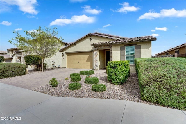 view of front of home with stucco siding, driveway, stone siding, a garage, and a tiled roof