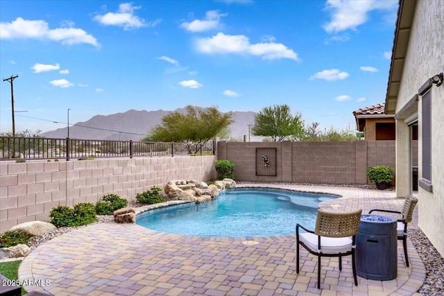 view of swimming pool featuring a mountain view, a patio, a fenced in pool, and a fenced backyard