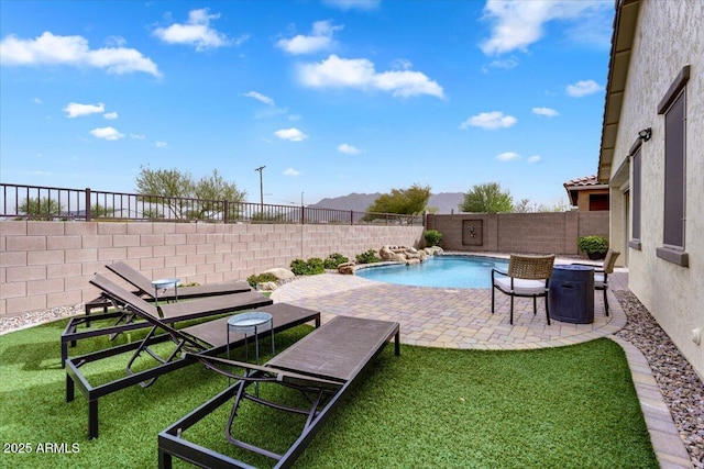 view of swimming pool featuring a patio, a yard, a fenced backyard, and a fenced in pool