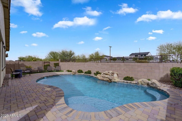 view of swimming pool with a fenced in pool, a patio, and a fenced backyard