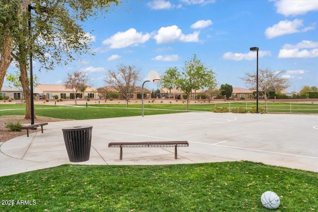 exterior space with a lawn and community basketball court