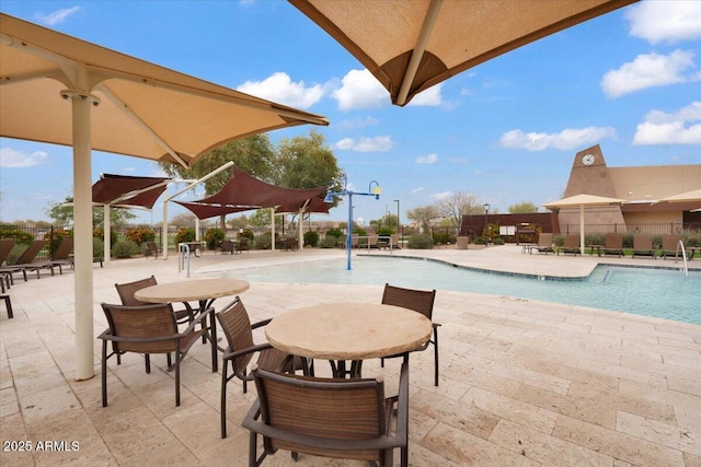 community pool featuring a patio and fence