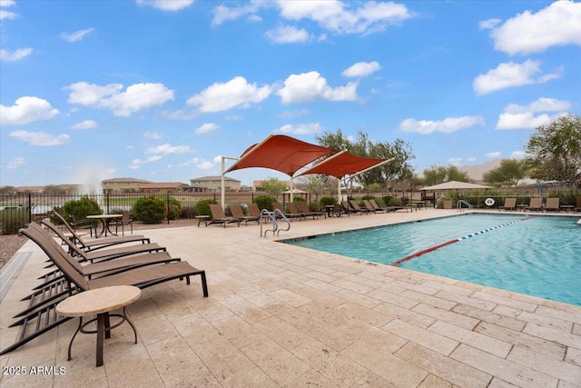 community pool featuring a patio and fence