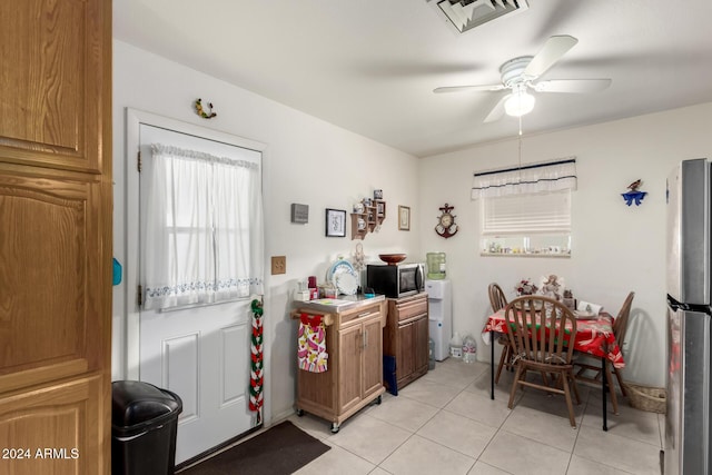 kitchen with appliances with stainless steel finishes, light tile patterned floors, and ceiling fan