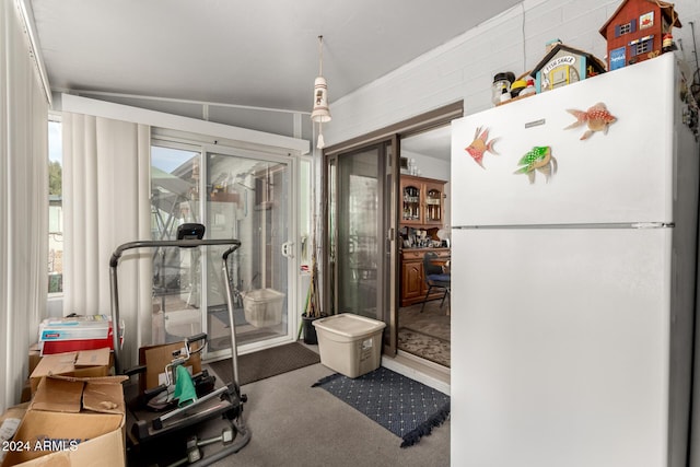 workout room featuring carpet floors and vaulted ceiling