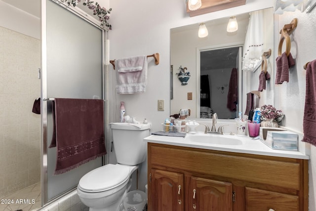 bathroom with walk in shower, vanity, and toilet