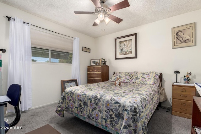 carpeted bedroom featuring ceiling fan and a textured ceiling