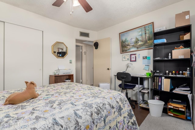 bedroom with a textured ceiling, a closet, and ceiling fan