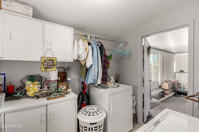 laundry area with cabinets and washing machine and dryer