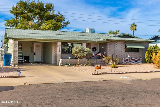 ranch-style home featuring a carport