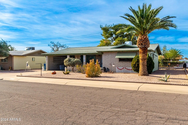 single story home featuring central AC unit