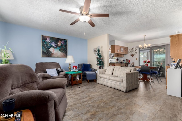 living room with a textured ceiling and ceiling fan with notable chandelier