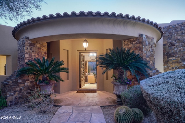 view of exterior entry featuring a patio area