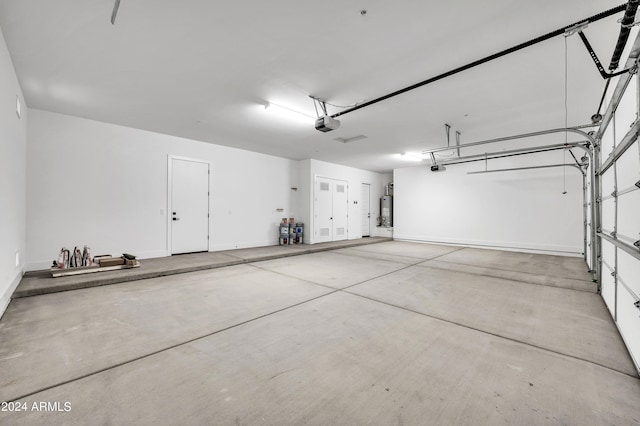 garage featuring water heater and a garage door opener