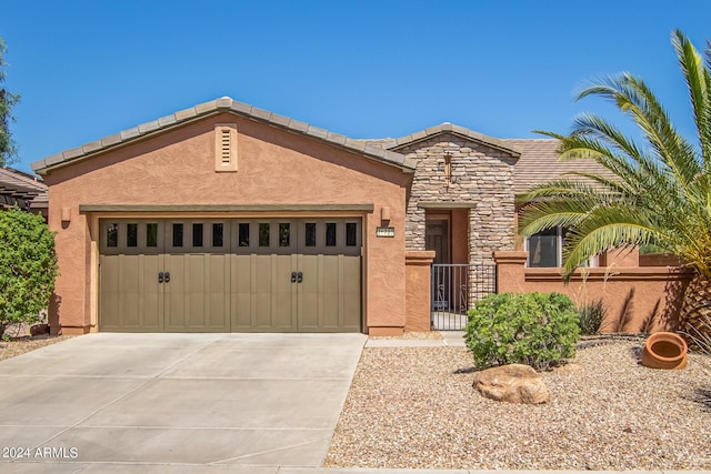 26723 N 127th Dr, Peoria, AZ 85383 - view of front of house with fence, concrete driveway, stucco siding, stone siding, and an attached garage
