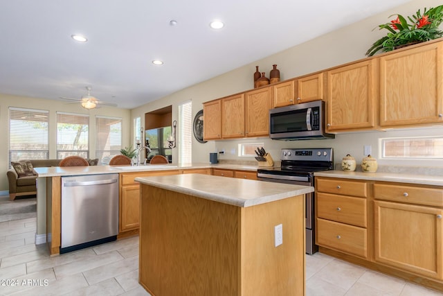 26723 N 127th Dr, Peoria, AZ 85383 - kitchen with a peninsula, ceiling fan, a sink, light countertops, and appliances with stainless steel finishes