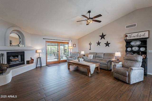15746 E Sycamore Dr, Fountain Hills, AZ 85268 - living area featuring dark wood-style flooring, visible vents, a fireplace with raised hearth, and lofted ceiling