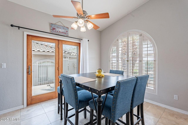 15746 E Sycamore Dr, Fountain Hills, AZ 85268 - dining space featuring light tile patterned floors, baseboards, a ceiling fan, and lofted ceiling