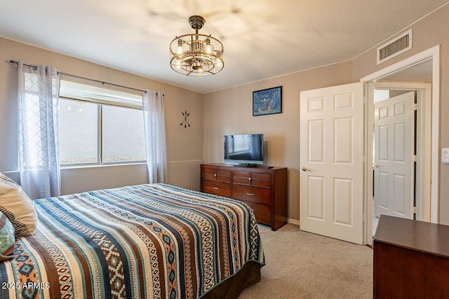 15746 E Sycamore Dr, Fountain Hills, AZ 85268 - bedroom featuring visible vents, light colored carpet, and an inviting chandelier