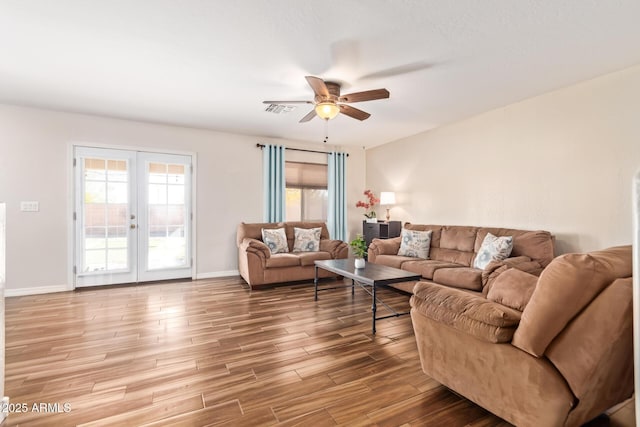 living room featuring wood-type flooring, french doors, and ceiling fan